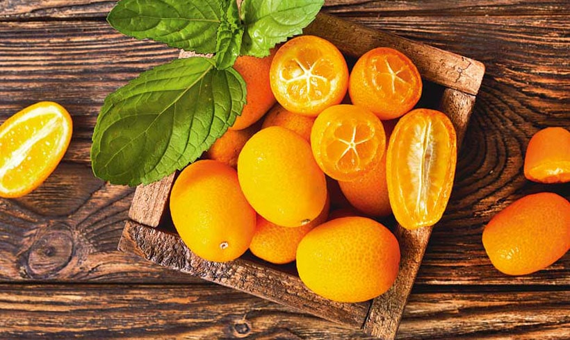 Kumquats On Wooden Background