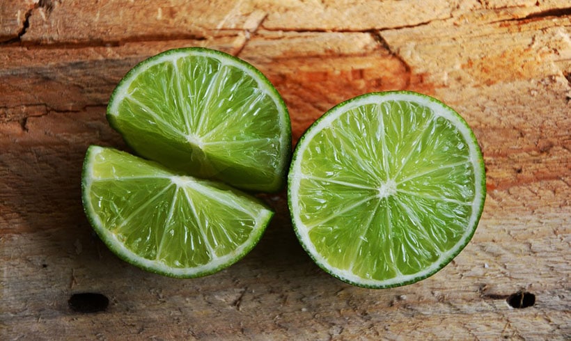 Limes On Wooden Background