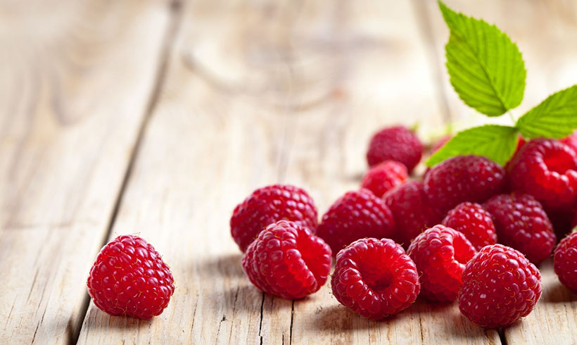 Raspberries on Wooden Table